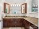 Bathroom with double sink vanity and granite countertop and open mirrored cabinets with decorative lighting at 7107 Cedarfield Rd, Charlotte, NC 28227
