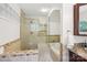 Bright bathroom features a tiled glass enclosed shower, soaker tub, and granite vanity at 7107 Cedarfield Rd, Charlotte, NC 28227