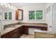 Bathroom featuring double sink vanity, granite countertops, and natural light at 7107 Cedarfield Rd, Charlotte, NC 28227