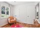 Cozy bedroom offers hardwood floors, an accent chair and window with plenty of natural light at 7107 Cedarfield Rd, Charlotte, NC 28227
