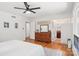 Bedroom featuring hardwood floors, ceiling fan, and a doorway leading to the attached bathroom at 7107 Cedarfield Rd, Charlotte, NC 28227