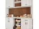 Office features shelving, white cabinets, marble countertops and cork accents at 7107 Cedarfield Rd, Charlotte, NC 28227
