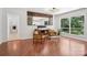 Open dining room with hardwood floors, modern lighting fixture, and lots of natural light at 7107 Cedarfield Rd, Charlotte, NC 28227