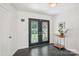 Inviting foyer with decorative double doors, stone tile flooring, and modern accents at 7107 Cedarfield Rd, Charlotte, NC 28227