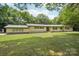 Charming ranch-style home with large front lawn and mature trees providing shade at 7107 Cedarfield Rd, Charlotte, NC 28227