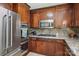 Kitchen features stainless steel appliances, wood cabinetry, gas range and stone countertops at 7107 Cedarfield Rd, Charlotte, NC 28227
