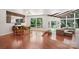 Spacious living room with hardwood floors, large windows, and comfortable seating at 7107 Cedarfield Rd, Charlotte, NC 28227
