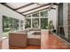 Bright living room with vaulted ceiling, large windows, fireplace, and cozy sectional couch at 7107 Cedarfield Rd, Charlotte, NC 28227