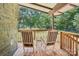 Cozy covered porch with rustic rocking chairs at 7107 Cedarfield Rd, Charlotte, NC 28227
