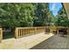Large wooden deck with comfortable seating, ideal for entertaining or enjoying peaceful moments at 7109 Forney Hill Rd, Denver, NC 28037