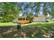 Inviting backyard showcasing a new wooden deck and a tranquil space for outdoor gatherings at 7109 Forney Hill Rd, Denver, NC 28037