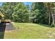 Expansive backyard with lush lawn and mature trees, creating a serene outdoor setting at 7109 Forney Hill Rd, Denver, NC 28037
