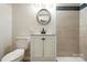Bathroom featuring vanity with cabinet and drawers, elongated toilet, and tile shower with stone accents at 7109 Forney Hill Rd, Denver, NC 28037