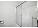Walk-in shower with glass sliding doors and tile surround at 7109 Forney Hill Rd, Denver, NC 28037