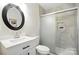 Modern bathroom with vanity, round mirror, and glass enclosed shower featuring attractive tile at 7109 Forney Hill Rd, Denver, NC 28037