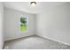 Bedroom featuring neutral carpet and large window offering lots of natural light at 7109 Forney Hill Rd, Denver, NC 28037