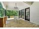Charming covered deck featuring an outdoor dining area and seamless flow to the interior at 7109 Forney Hill Rd, Denver, NC 28037