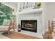 Close-up of the fireplace with decorative mantel and hearth, complemented by elegant seating at 7109 Forney Hill Rd, Denver, NC 28037