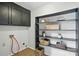 Functional laundry room with ample storage cabinets and open shelving for organizing essentials at 7109 Forney Hill Rd, Denver, NC 28037