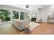 Inviting living area featuring a cozy fireplace, large windows, and comfortable seating at 7109 Forney Hill Rd, Denver, NC 28037