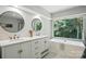 Spa-like main bathroom features a dual sink vanity, modern fixtures, and a garden tub at 7109 Forney Hill Rd, Denver, NC 28037