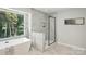 Modern bathroom featuring a large soaker tub, glass shower, and marble tiling at 7109 Forney Hill Rd, Denver, NC 28037