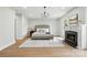 Serene main bedroom with fireplace, large windows, and modern chandelier at 7109 Forney Hill Rd, Denver, NC 28037