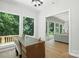 Well-lit home office featuring a large window with a view and functional desk setup at 7109 Forney Hill Rd, Denver, NC 28037