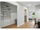 Walk-in closet with built-in shelving, recessed lighting, and hardwood flooring at 7109 Forney Hill Rd, Denver, NC 28037