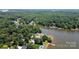 Expansive aerial view of a lakefront home with a private dock and lush green surroundings at 735 Pebble Pt, Salisbury, NC 28146