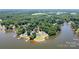Beautiful aerial view of a home, showing lake access, a swimming pool, and mature trees at 735 Pebble Pt, Salisbury, NC 28146