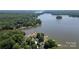 Breathtaking aerial view featuring a beautiful lake and lush greenery surrounding the luxurious lakeside property at 735 Pebble Pt, Salisbury, NC 28146