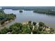 Stunning aerial view showcasing the home's lakeside location and lush green surroundings, perfect for nature lovers at 735 Pebble Pt, Salisbury, NC 28146