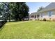 Spacious backyard features a playset, fire pit, and a covered porch at 735 Pebble Pt, Salisbury, NC 28146