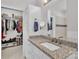 Well-lit bathroom featuring a granite countertop vanity and a walk-in closet at 735 Pebble Pt, Salisbury, NC 28146