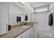 Bright bathroom featuring granite countertop, white cabinetry, and a shower with tub at 735 Pebble Pt, Salisbury, NC 28146