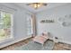 Cozy bedroom with natural light, hardwood floors and a soft blue rug at 735 Pebble Pt, Salisbury, NC 28146