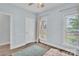 Bright, airy bedroom with hardwood flooring, two windows, and soft blue walls at 735 Pebble Pt, Salisbury, NC 28146
