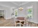 Bright dining area with hardwood floors, a chandelier, and natural light at 735 Pebble Pt, Salisbury, NC 28146