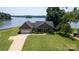 Charming waterfront home with lush lawn, mature trees, and a tranquil lake view at 735 Pebble Pt, Salisbury, NC 28146