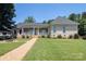 Brick home with a charming porch, brick walkway, and manicured lawn at 735 Pebble Pt, Salisbury, NC 28146