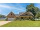 Inviting brick home with a well-manicured lawn, mature trees, and a two-car garage, near the lake at 735 Pebble Pt, Salisbury, NC 28146