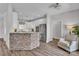 Open kitchen boasts stainless appliances, stone-clad breakfast bar, and sleek white cabinetry at 735 Pebble Pt, Salisbury, NC 28146