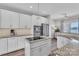 Spacious kitchen with stainless steel appliances, white cabinets, and granite countertops at 735 Pebble Pt, Salisbury, NC 28146