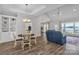 Open-concept living room with hardwood floors, a chandelier, and lake views at 735 Pebble Pt, Salisbury, NC 28146