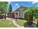 Green backyard featuring a stone pathway that leads to an outdoor kitchen with a red pergola at 8712 Soaring Eagle Ln, Waxhaw, NC 28173