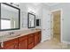 Elegant bathroom featuring dual sinks, wood cabinets, and a linen closet at 8712 Soaring Eagle Ln, Waxhaw, NC 28173