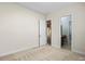 A carpeted bedroom showcasing natural light and adjacent bathroom at 8712 Soaring Eagle Ln, Waxhaw, NC 28173