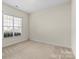 Bright bedroom with large window providing natural light and neutral decor at 8712 Soaring Eagle Ln, Waxhaw, NC 28173