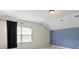 Cozy bedroom featuring a large window, neutral carpet, and blue accent wall at 8712 Soaring Eagle Ln, Waxhaw, NC 28173
